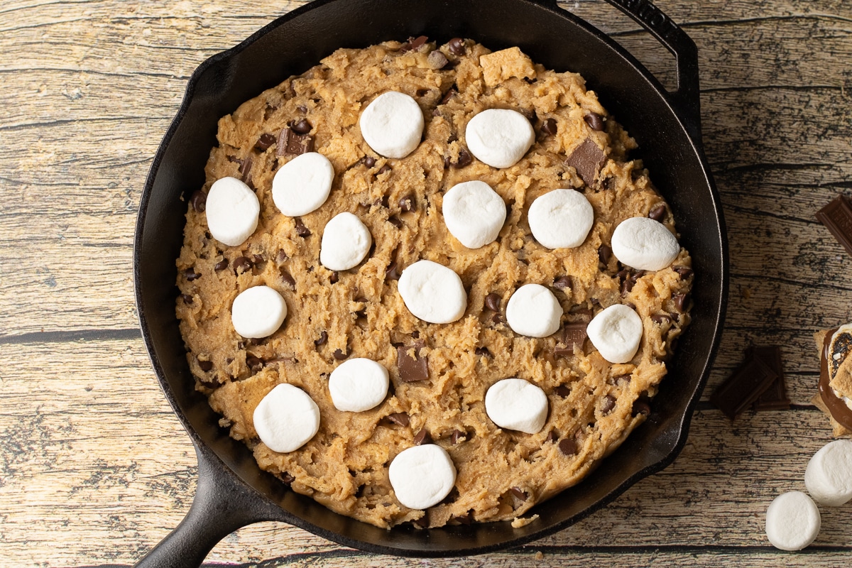 overhead view of an uncooked smores cookie topped with marshmallows