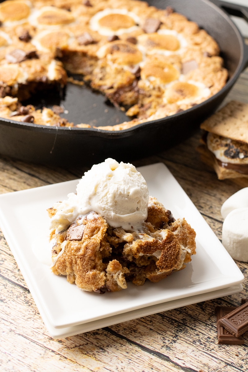 Brown Butter S’mores Skillet Cookie baked in a cast iron skillet with golden edges, melted chocolate, and toasted marshmallows on top, ready to be served warm.