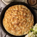 overhead view of focaccia baked in a cast iron skillet