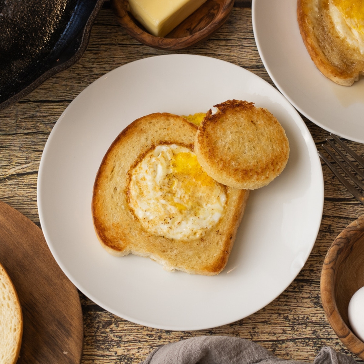 bread with a hole in the center and an egg cooked in the middle
