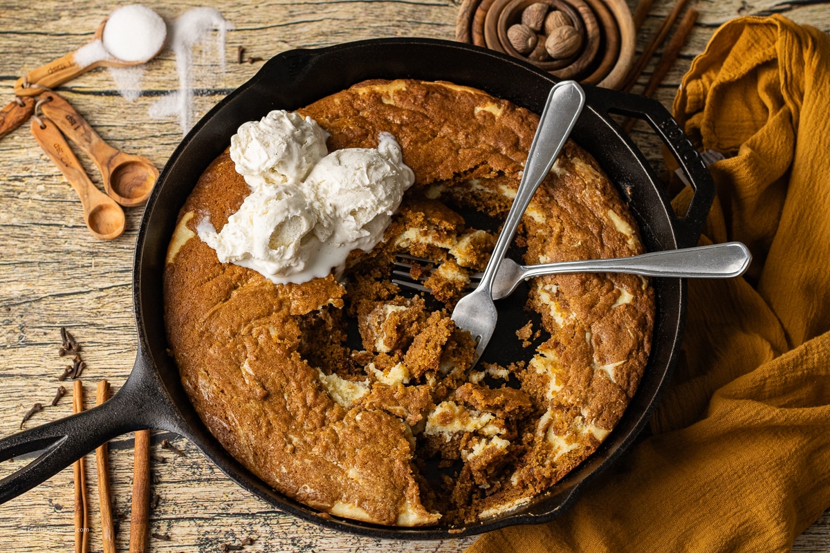 baking a pumpkin cookie with a cheesecake layer in a cast iron skillet