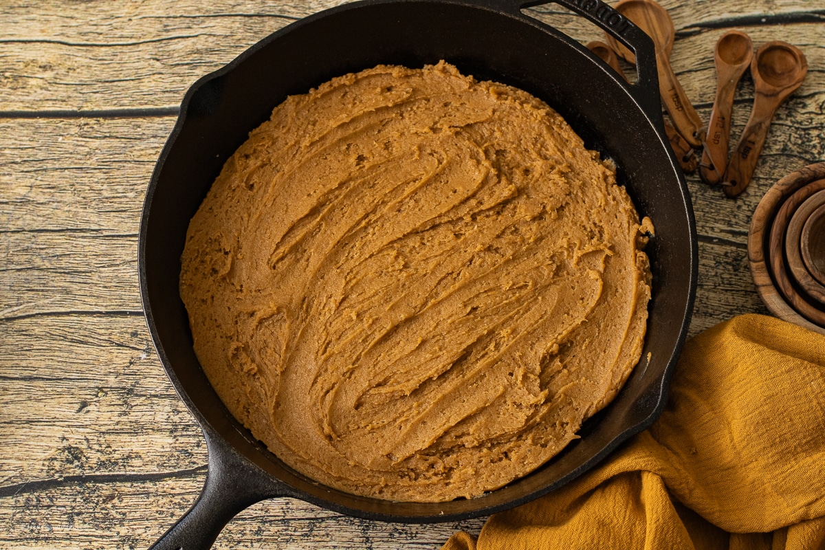 preparing a pumpkin cookie baked in a cast iron skillet 