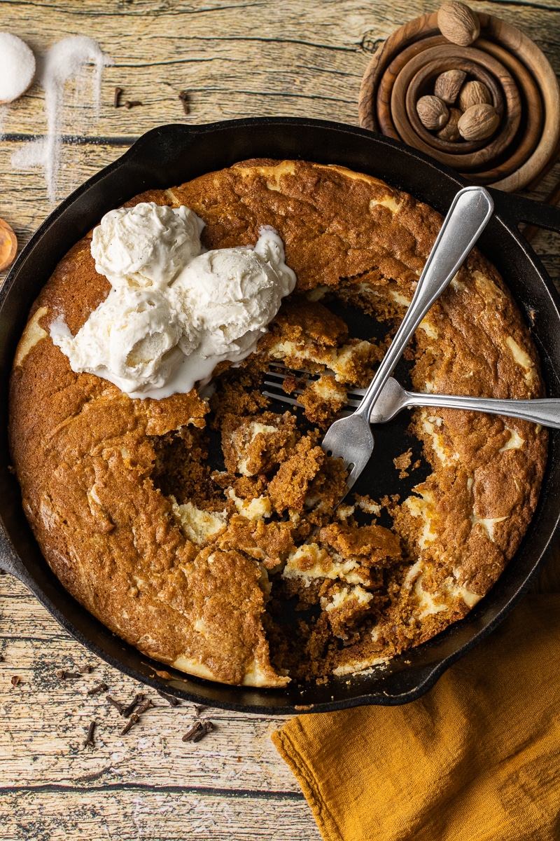 This skillet cookie recipe, Pumpkin Cheesecake Skillet Cookie is the sweetest, warm treat that will instantly become a fam favorite. Picture the warm flavors of cinnamon, nutmeg, cloves and ginger combined with the flavors of pumpkin and cream cheese-all baked in a cast iron skillet.