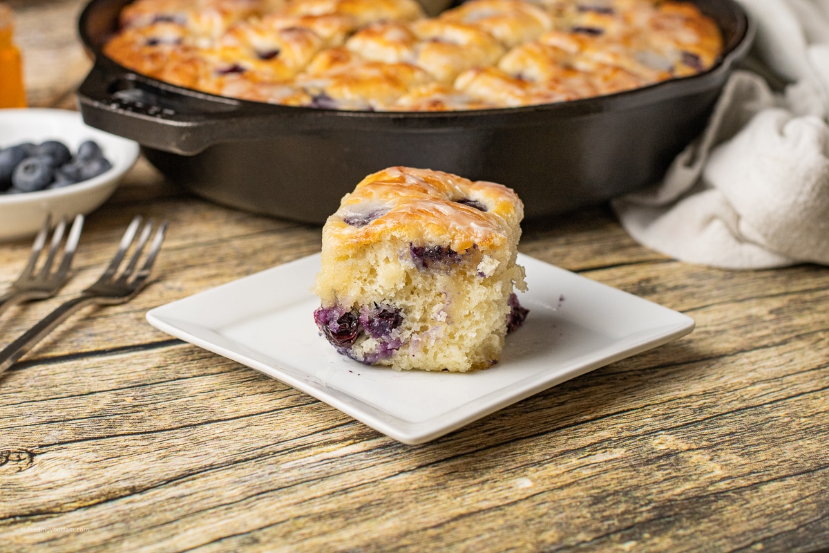 butter swim biscuits with blueberries in a cast iron skillet