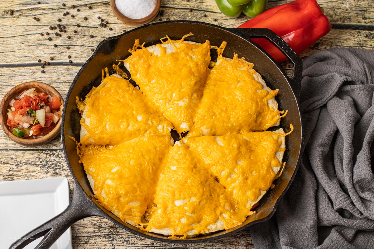 tortilla triangles filled with scrambled eggs and covered with melted cheddar cheese.