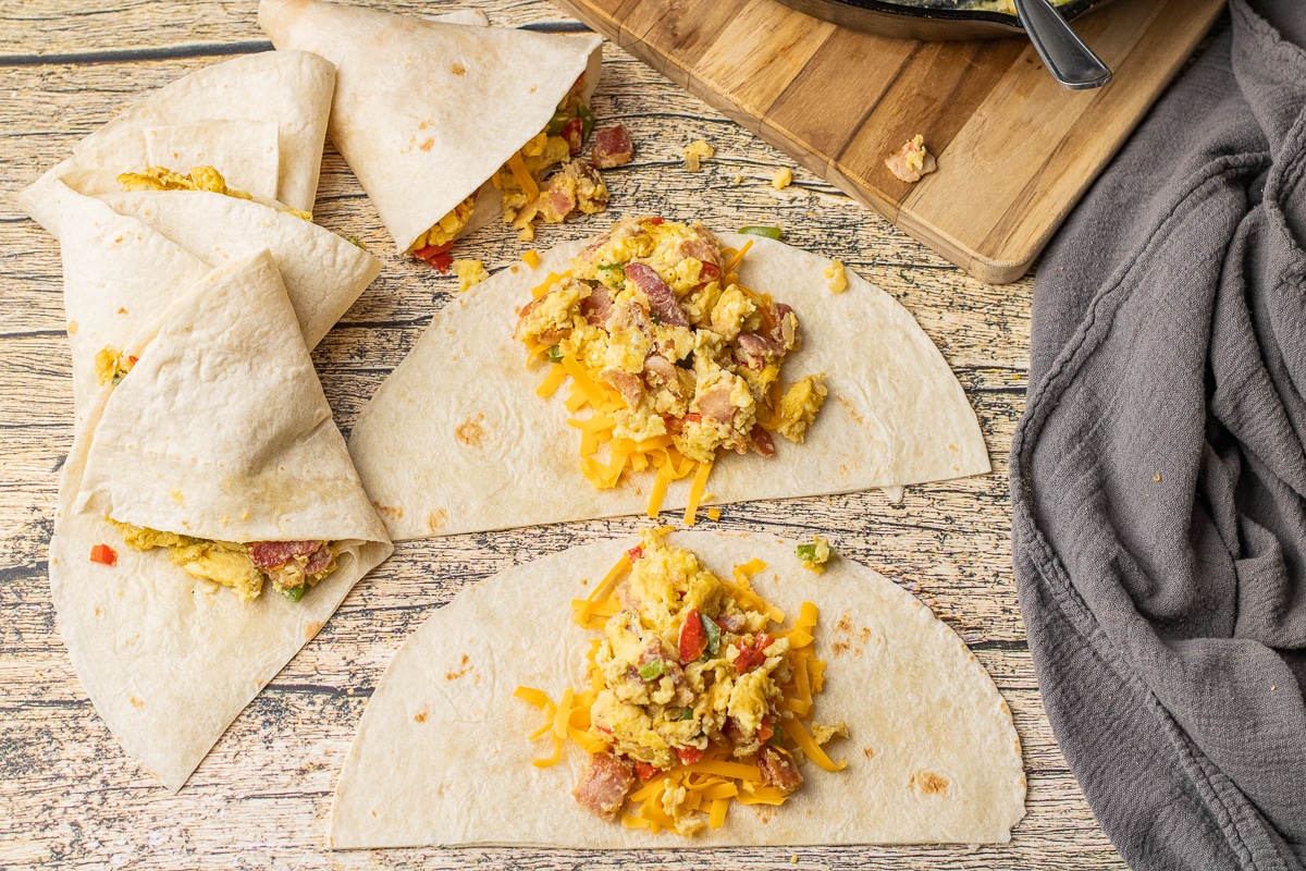 tortillas topped with scrambled eggs and cheese