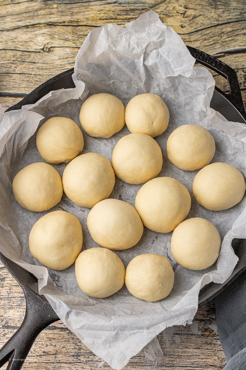 rolled out ball of bread dough in a cast iron skillet