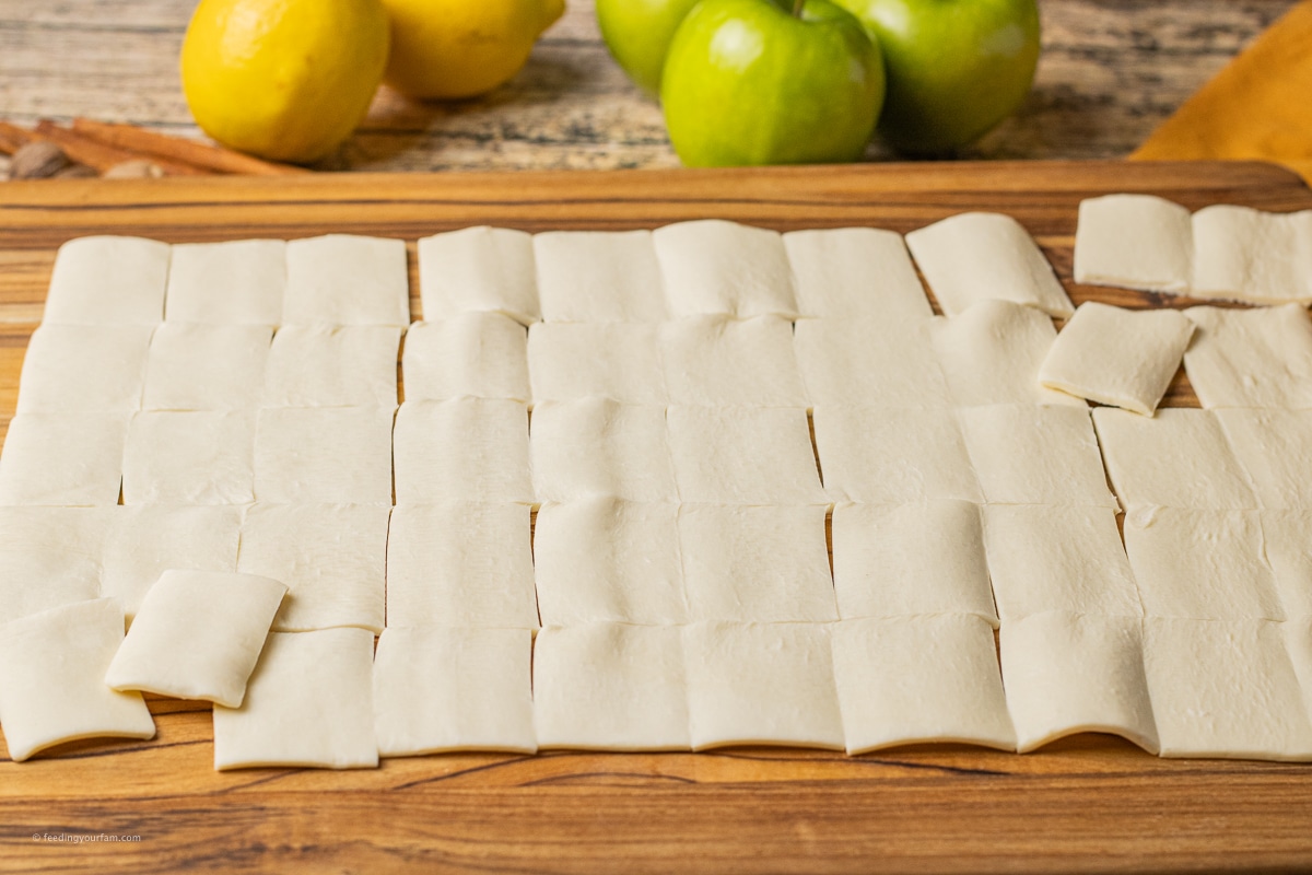 puff pastry sliced into rectangles on a wooden cutting board