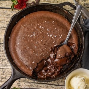 rich, chocolate lava cake in a cast iron skillet