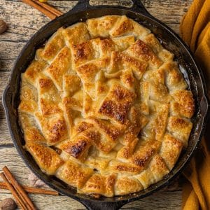 puff pastry apple pie baked in a cast iron skillet