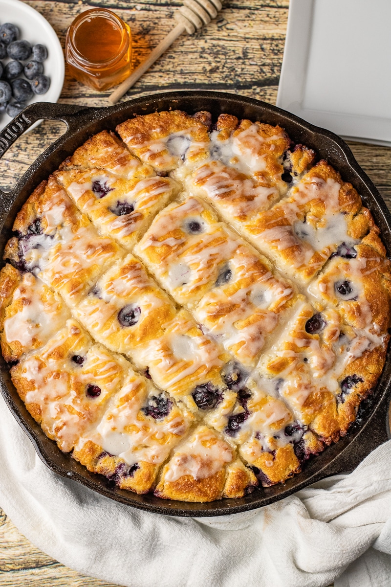 butter swim biscuits with blueberry baked in a cast iron skillet