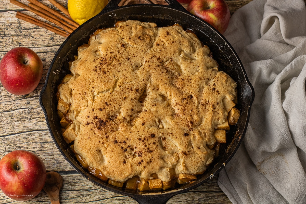 cast iron apple cobbler with a cake topping and spiced apples underneath