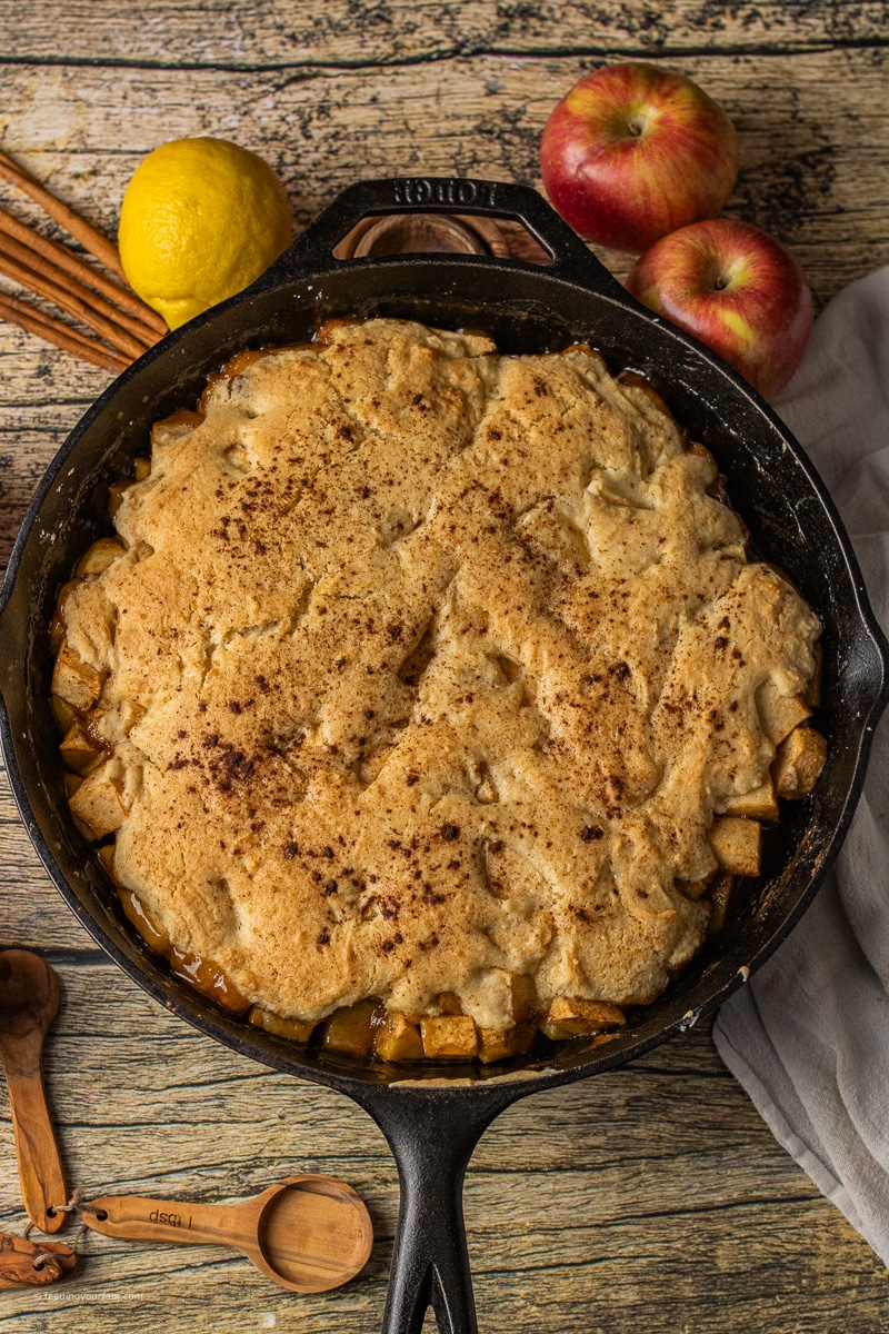 cast iron skillet apple cobbler with bubbling caramel sauce and soft apples