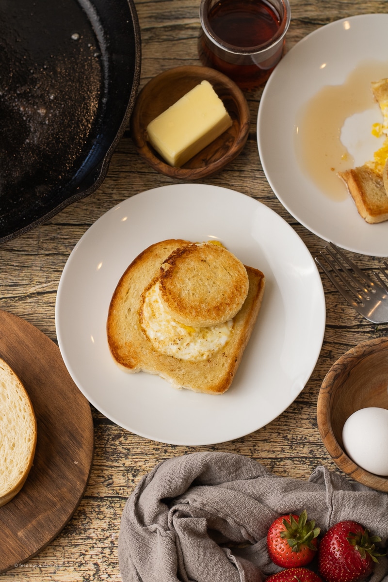 egg in a hole breakfast with a piece of bread with a circle in the center and an egg cooked in the middle