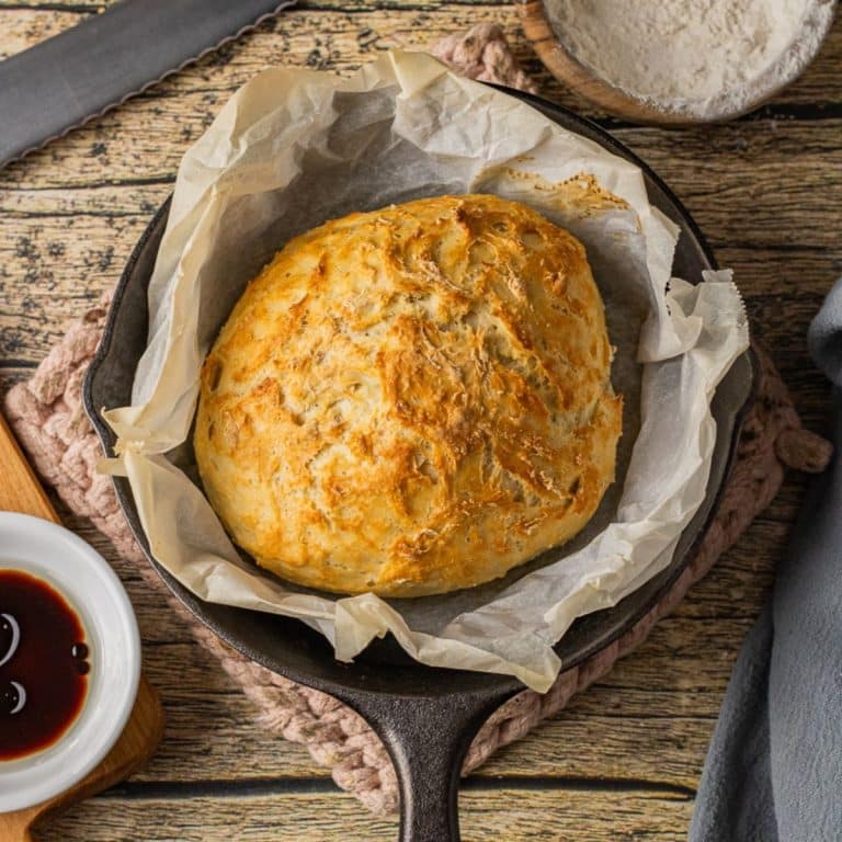small loaf of bread baked in a cast iron skillet