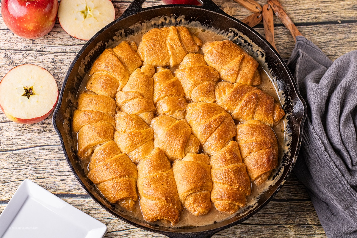 easy apple dumpling recipe with a homemade caramel sauce in a cast iron skillet