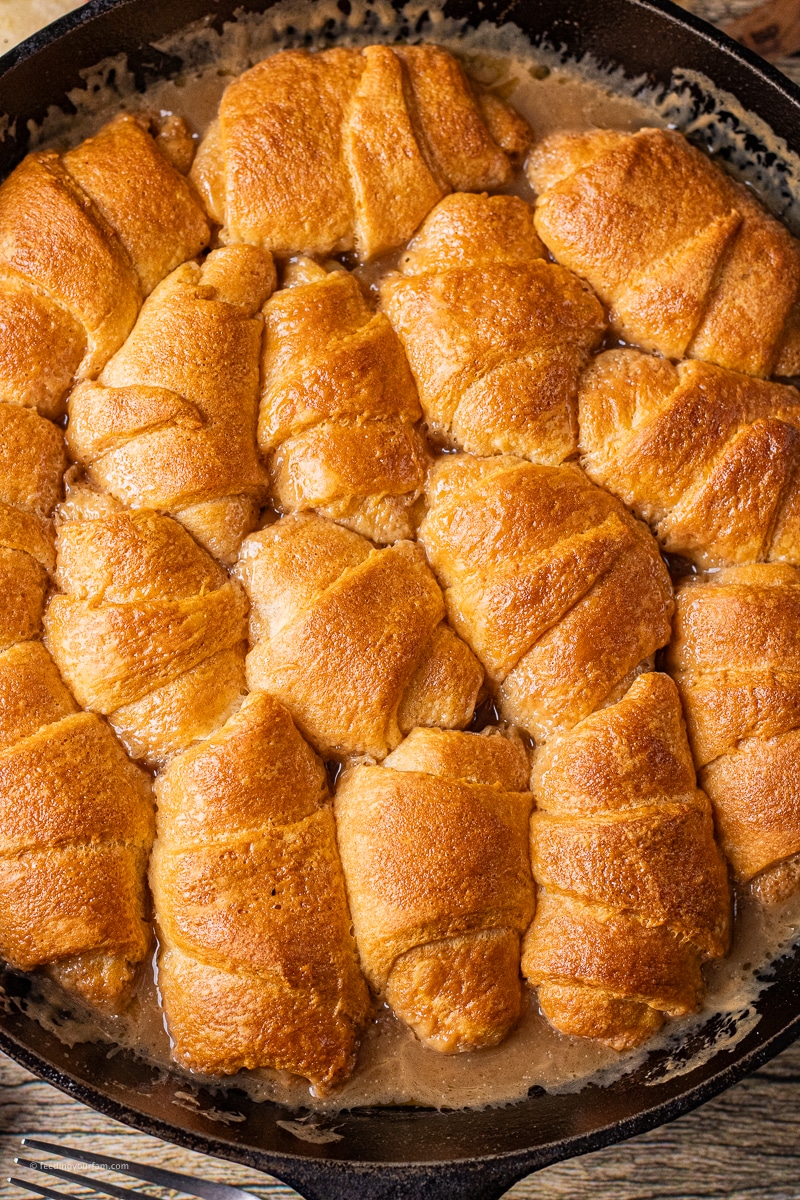 easy apple dumpling recipe with caramel sauce in a cast iron skillet