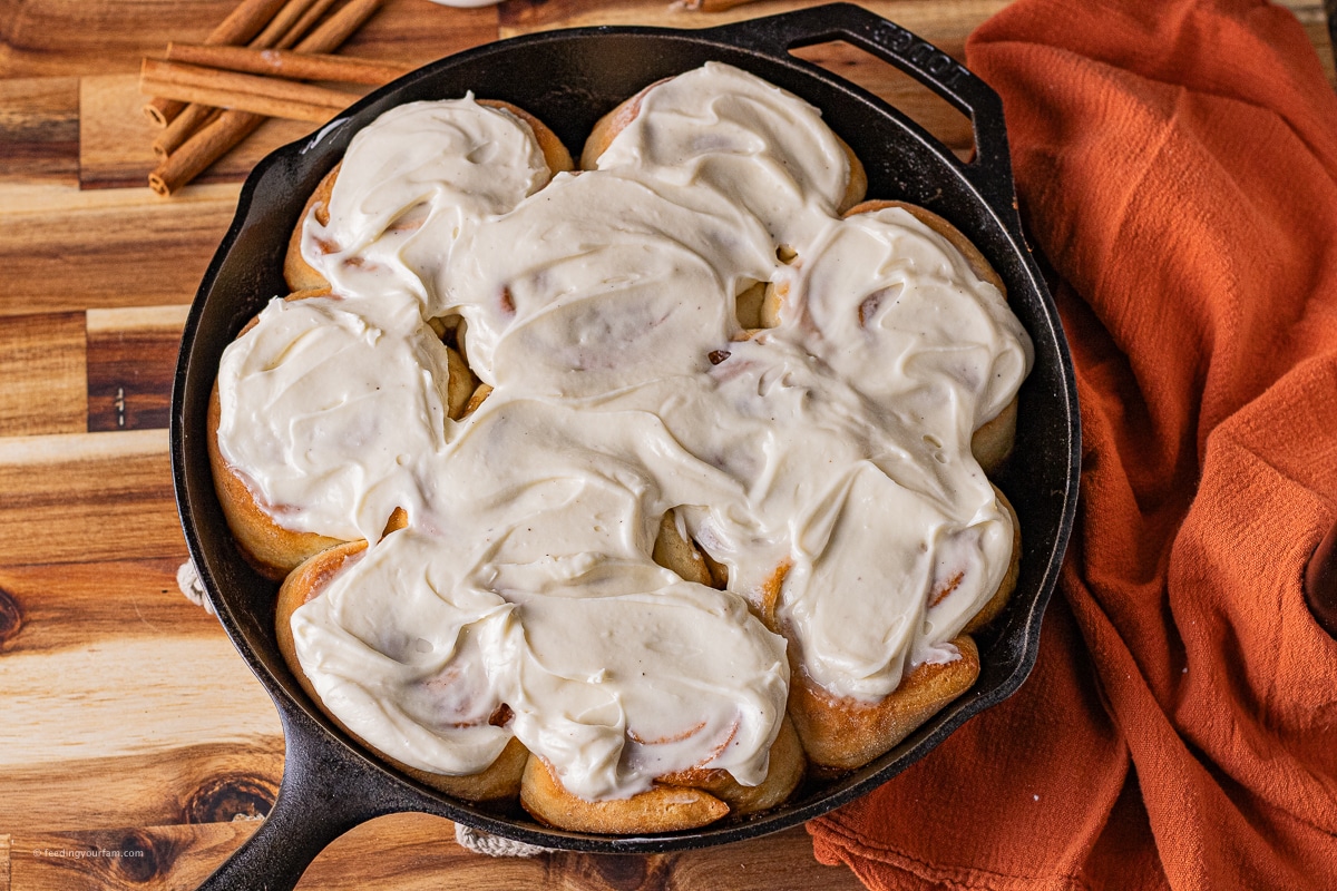 cast iron cinnamon rolls topped with cream cheese frosting