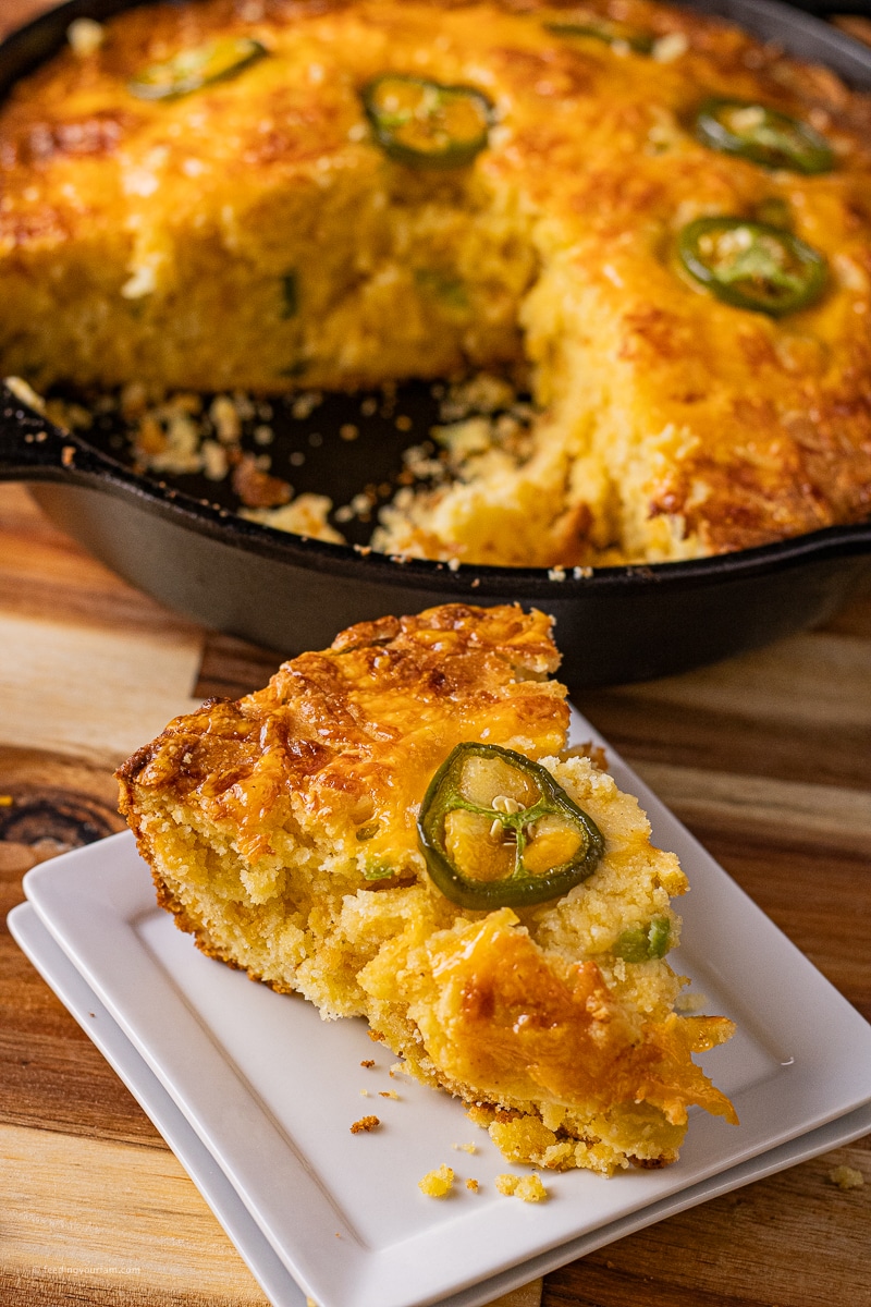 jalapeno cheddar cheese cornbread slice baked in a cast iron skillet