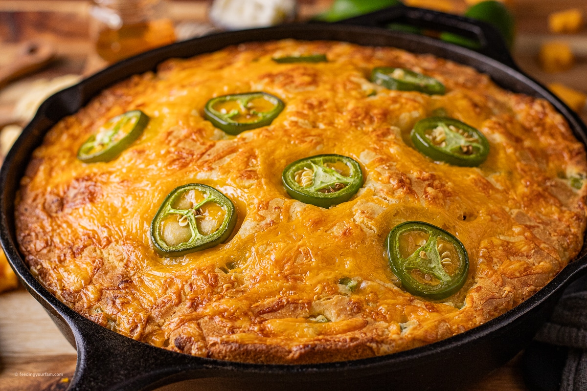jalapeno cheddar cheese cornbread baked in a cast iron skillet