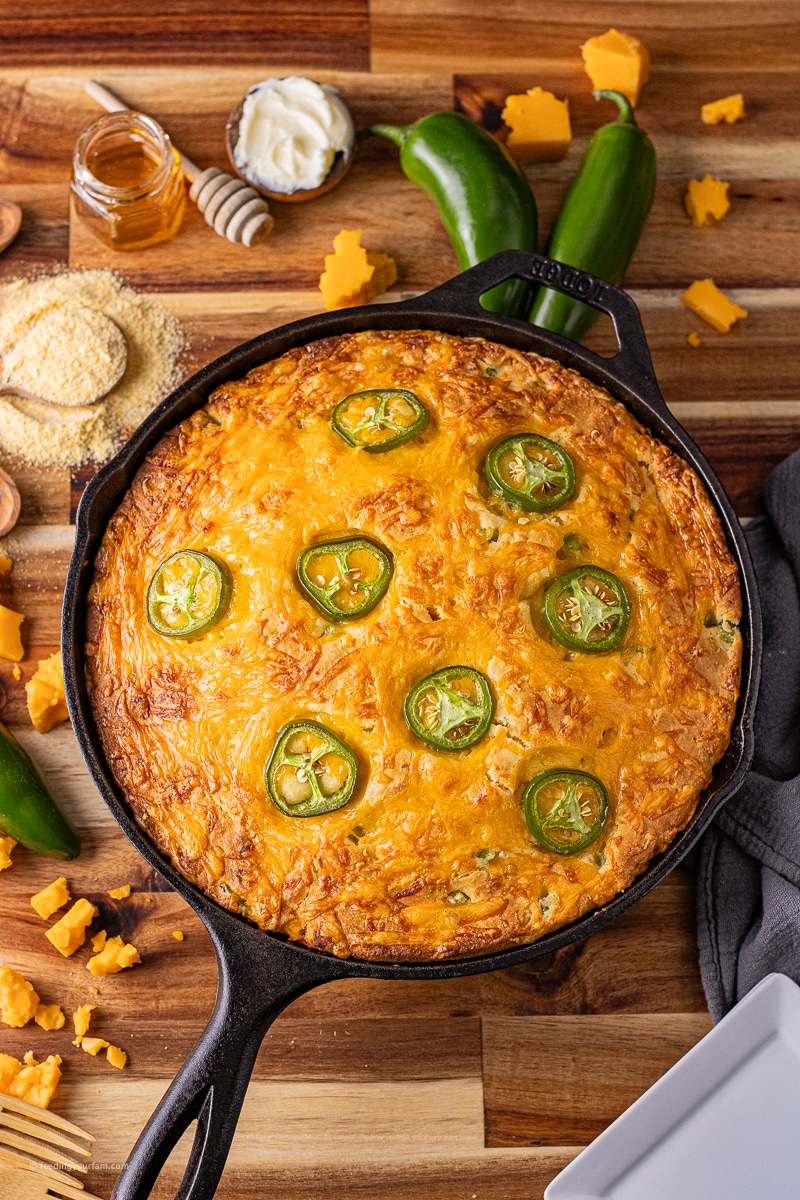This Jalapeno Cheddar Cornbread is so full of flavor! Fresh jalapenos and cheddar cheese help make this cornbread recipe rich and delicious. Baked in a cast iron skillet for a perfectly crisp outer crust and soft, fluffy, moist center.