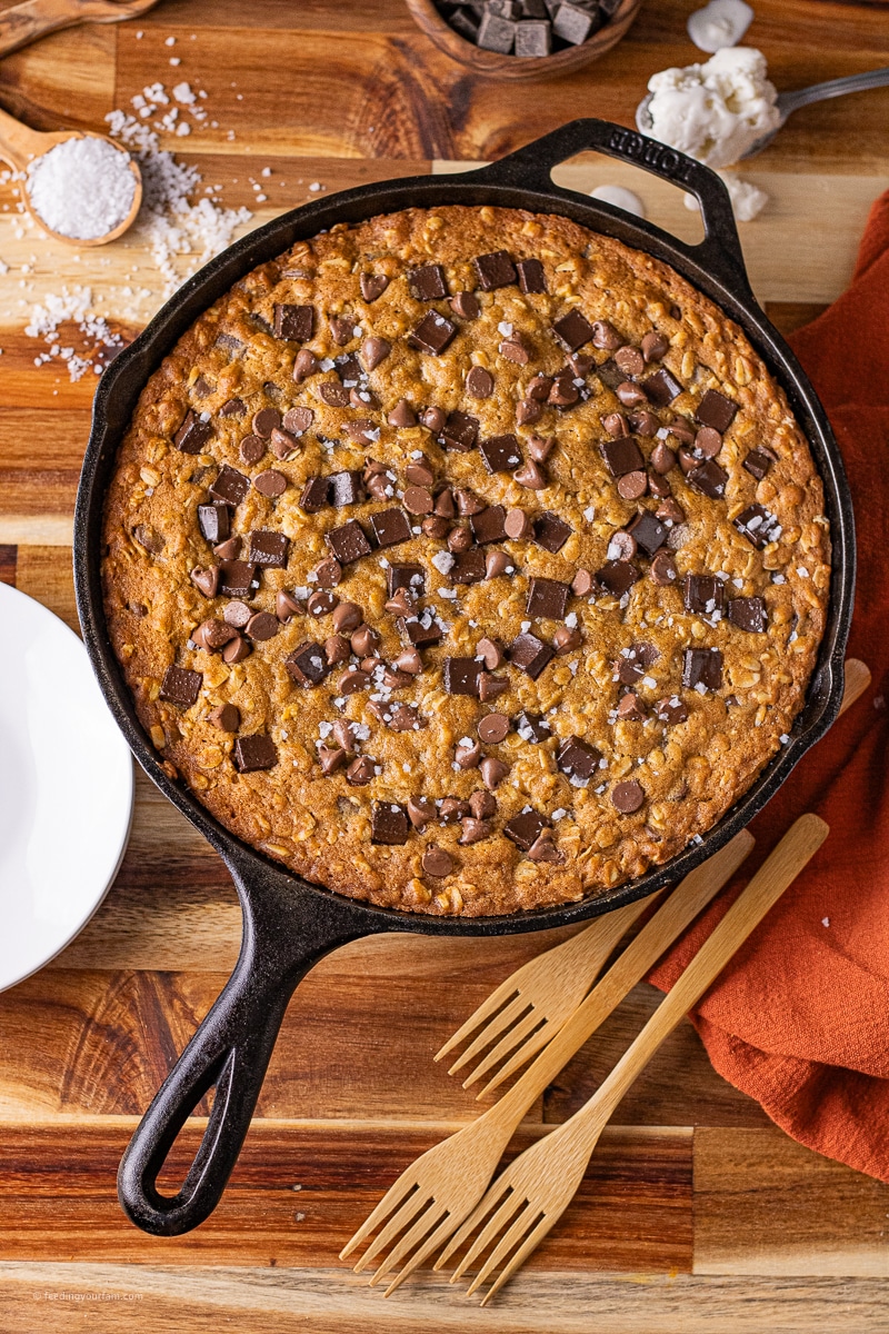 pumpkin chocolate chip cookie baked in a cast iron skillet with melted chocolate chips on top